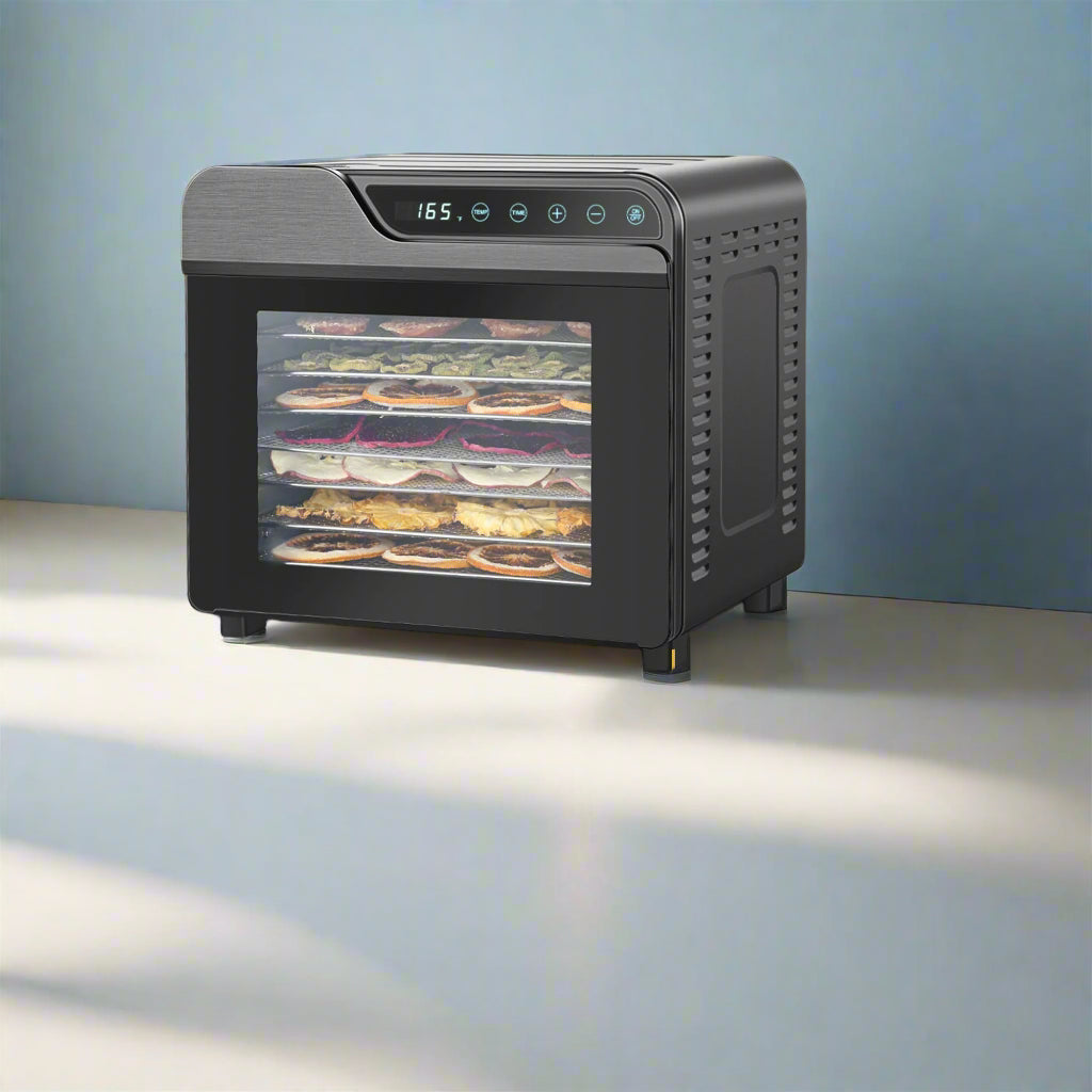 Black food dehydrator with dimensions and included items on a kitchen counter.
