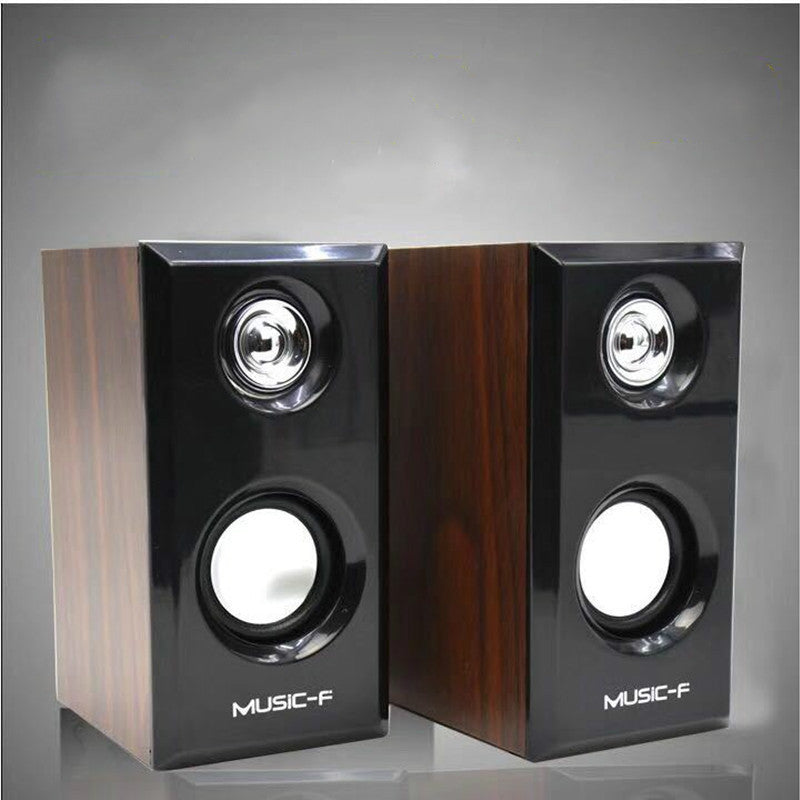 Pair of black and wood-patterned speakers with 'MUSIC-F' branding on a gray background