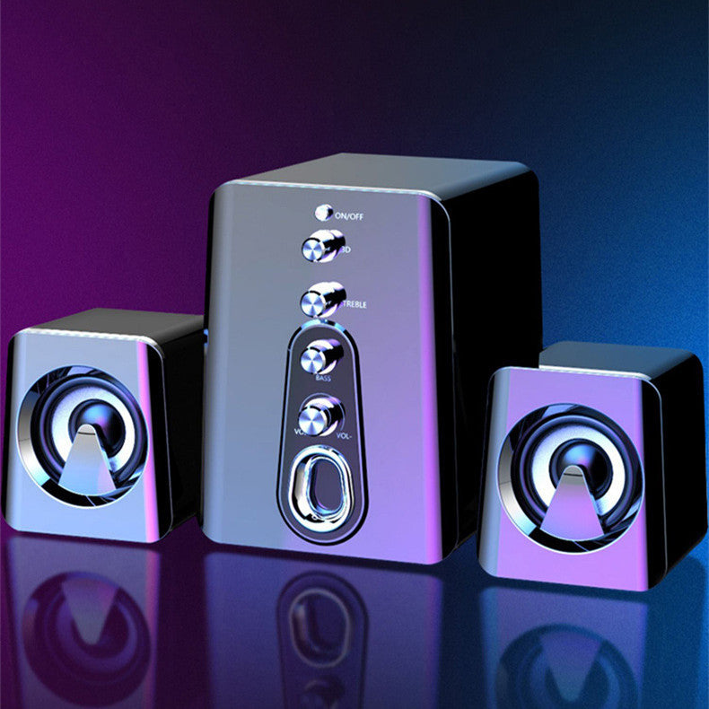 Set of three silver speakers on a reflective surface with a gradient background