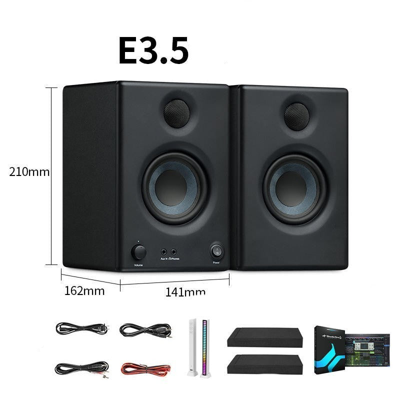 Pair of black speakers with dimensions and included accessories on a white background
