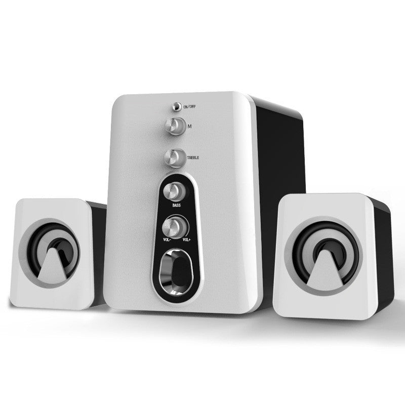 White computer speakers with control buttons on a white background