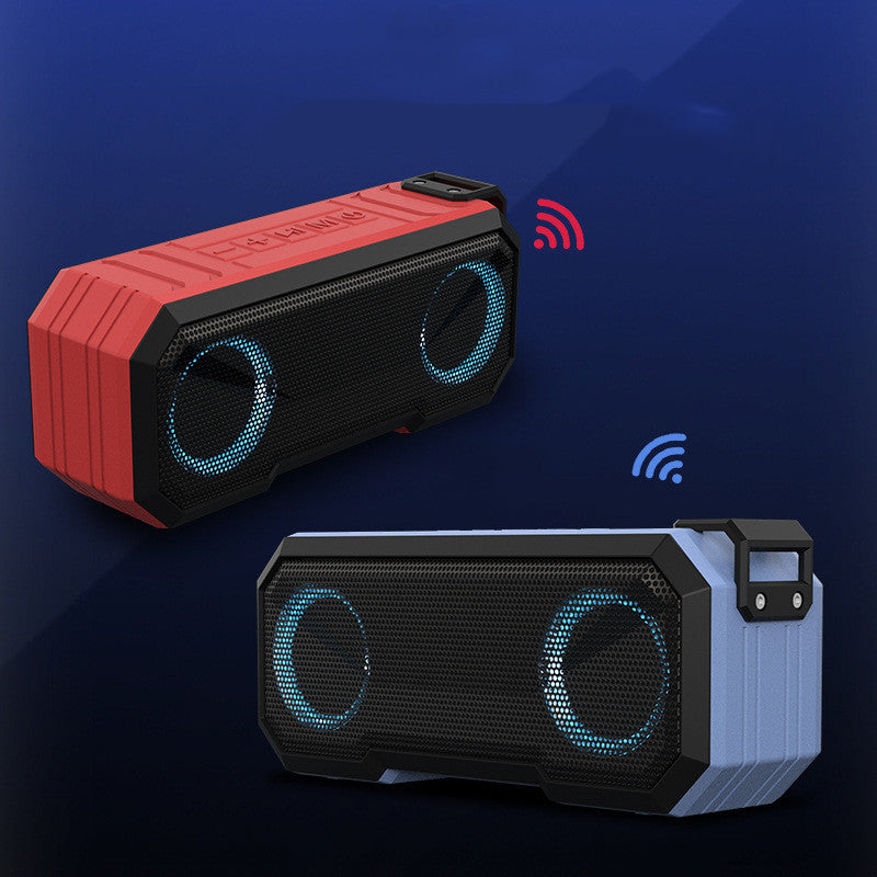Two portable Bluetooth speakers, one red and black, one black and gray, on a dark blue background.